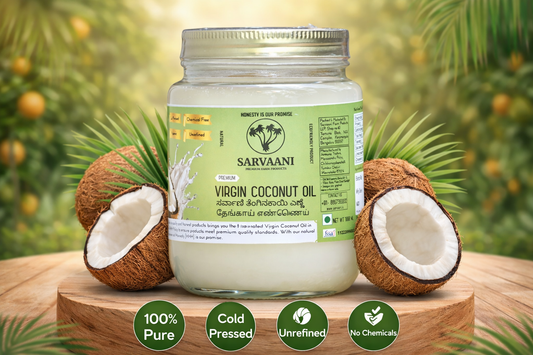 Jar of Sarvaani Virgin Coconut Oil with coconuts on a wooden surface and greenery in the background