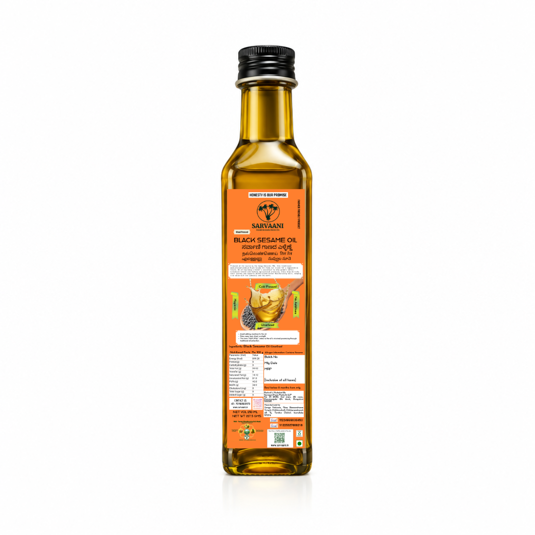 A bottle of Marigold Black Sesame Oil, 500ml, shown from the back against a white background. The bottle is filled with golden-yellow oil and features a black screw cap and an orange label with product details. Sarvaani Sesame Oil