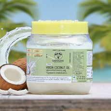 Jar of Suryavani Virgin Coconut Oil with a coconut and palm trees in the | 500ML_SArvaani VCO