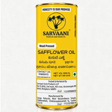 A tall cylindrical yellow tin of Sarvaani Safflower Oil, wood pressed, with black text and logo, photographed against a plain white background.