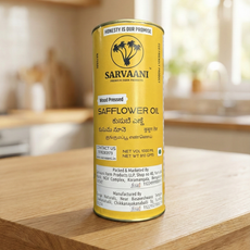 Can of Sarvaani safflower oil on a wooden surface with a blurred kitchen background